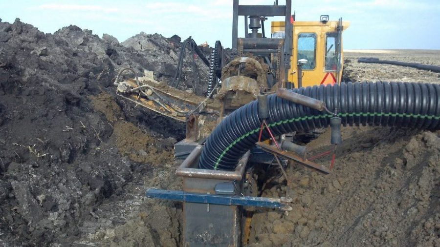 GPS tile plow installing drainage tile in an Iowa field