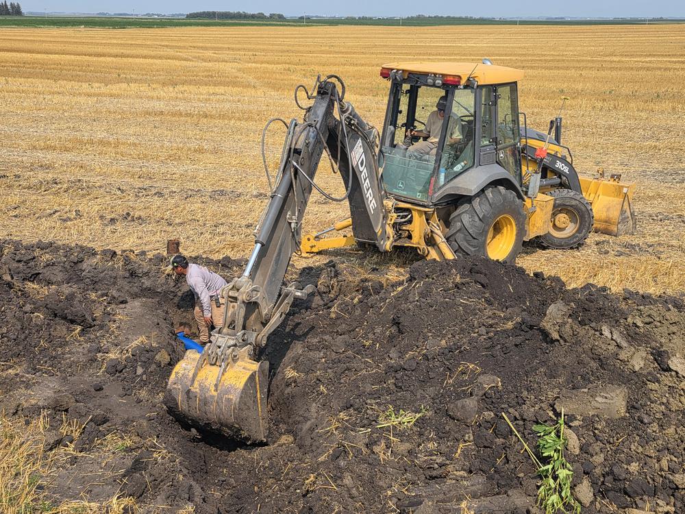 Heinsohn Digging & Tiling truck hauling equipment near Storm Lake, Iowa